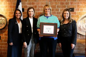Kristi Mentink, Prairie Lakes Regional Teacher of the Year and finalist for the 2026 Iowa Teacher of the Year, stands with Iowa Governor, Iowa Department of education director, and Lt. Gov